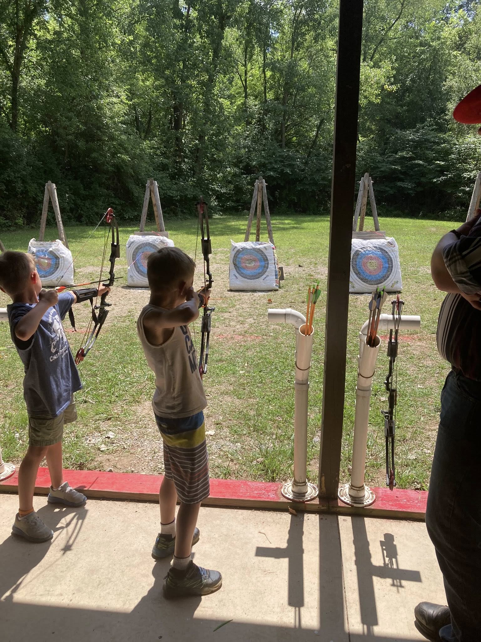 Cub Scouts practicing archery at a camp event